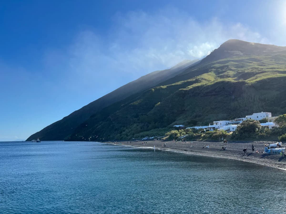 Breathtaking seaside view of Stromboli Island, showcasing a dramatic volcanic landscape and serene waters.